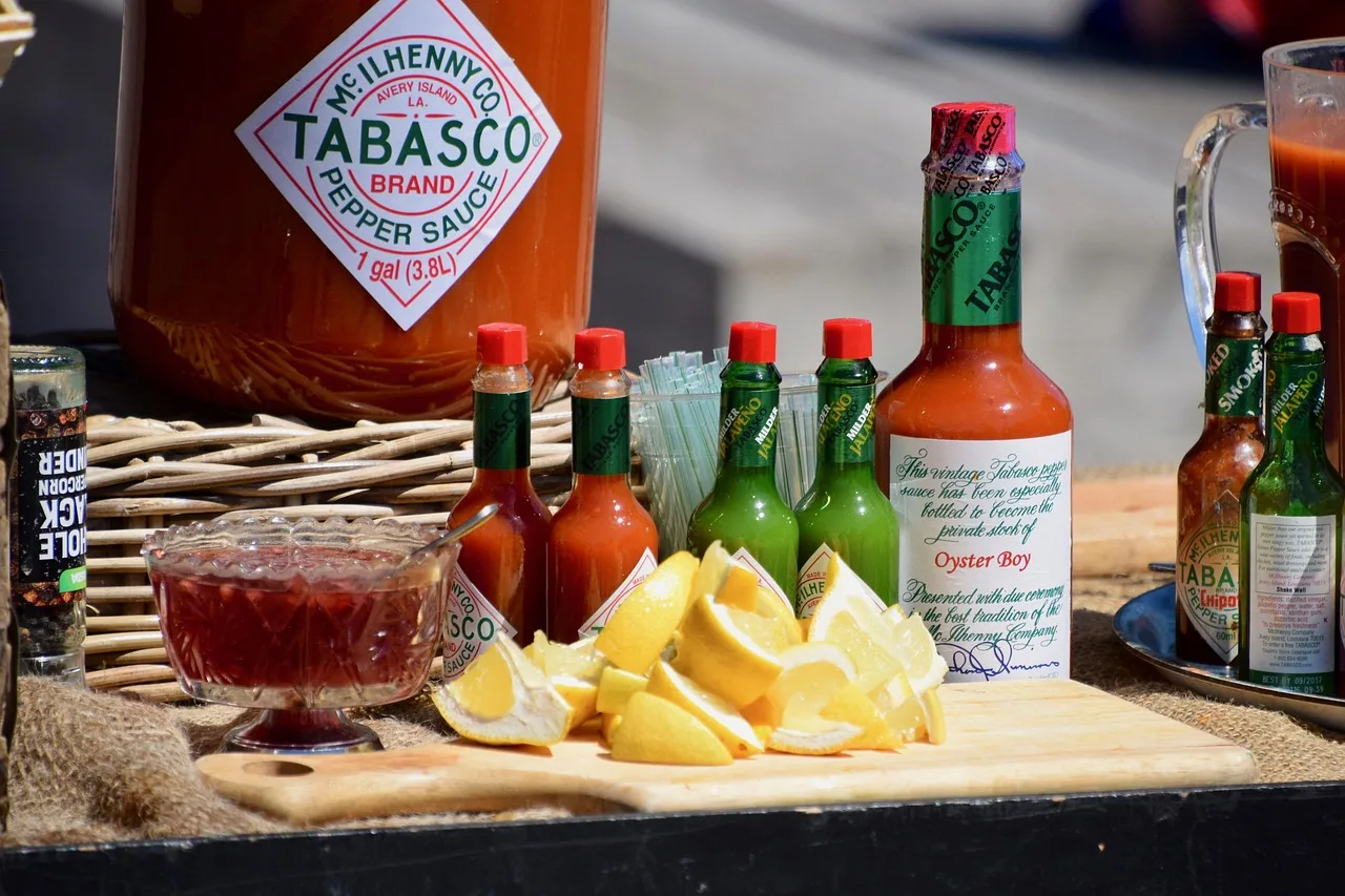 display table, food, food stall, lemon slices, lemons, food market, market stall, sauce, sauces, tabasco sauce, hot pepper sauce, outdoors, tabasco sauce, tabasco sauce, tabasco sauce, tabasco sauce, tabasco sauce. Regional American foods businesses: five buyer questions
