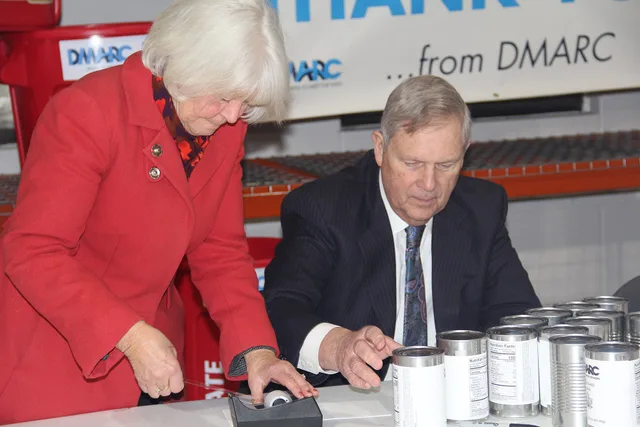 U.S. Department of Agriculture (USDA) Secretary Tom Vilsack and his wife, Christie Vilsack, attach labels to generic cans of beans donated to the Des Moines Area Religious Council (DMARC) – Food Pantry Network warehouse. The Secretary and his spouse toured the facility on the southside of Des Moines. How the FTC treats Made in USA claims on US pantry labels